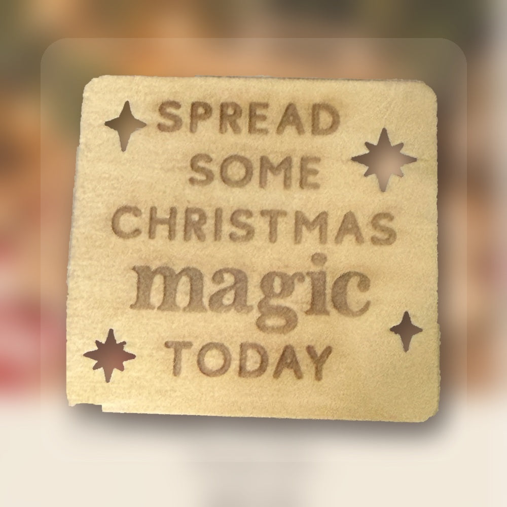 Styled holiday photograph composite made using the authentic engraved wooden Spread Some Christmas Magic sign