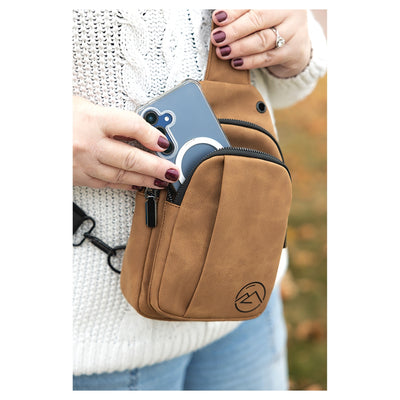 Personalized leather sling bag in cognac with mountain monogram engraving
