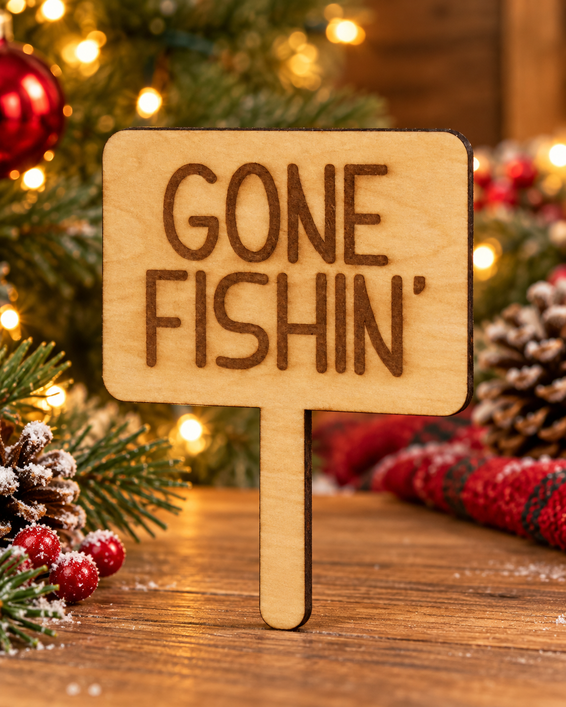 Festive lifestyle concept of laser-cut wooden Christmas Helper prop; original product photograph shows exact engraving and shape