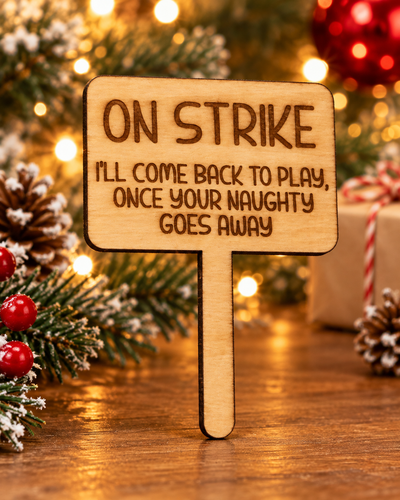 Festive lifestyle concept of laser-cut wooden Christmas Helper prop; original product photograph shows exact engraving and shape