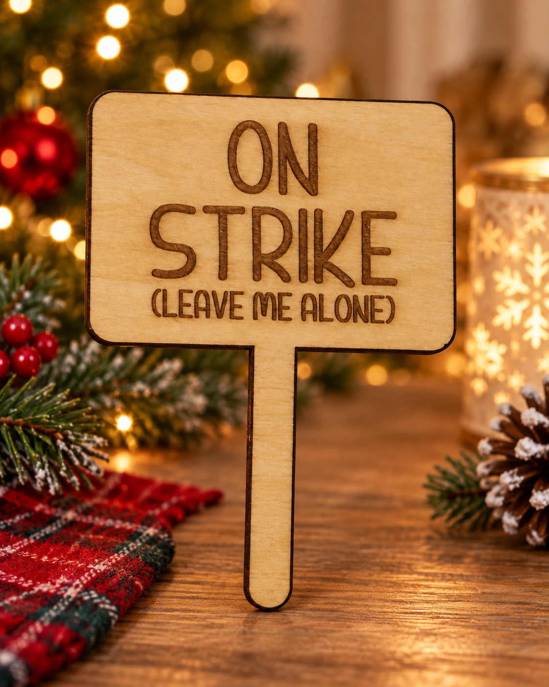 Festive lifestyle concept of laser-cut wooden Christmas Helper prop; original product photograph shows exact engraving and shape