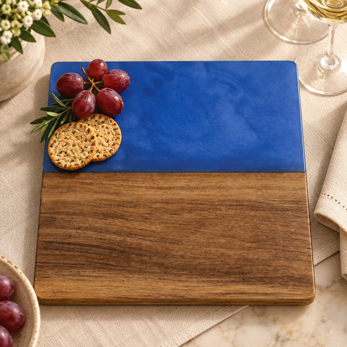 Blank marble and acacia serving board on a dining table